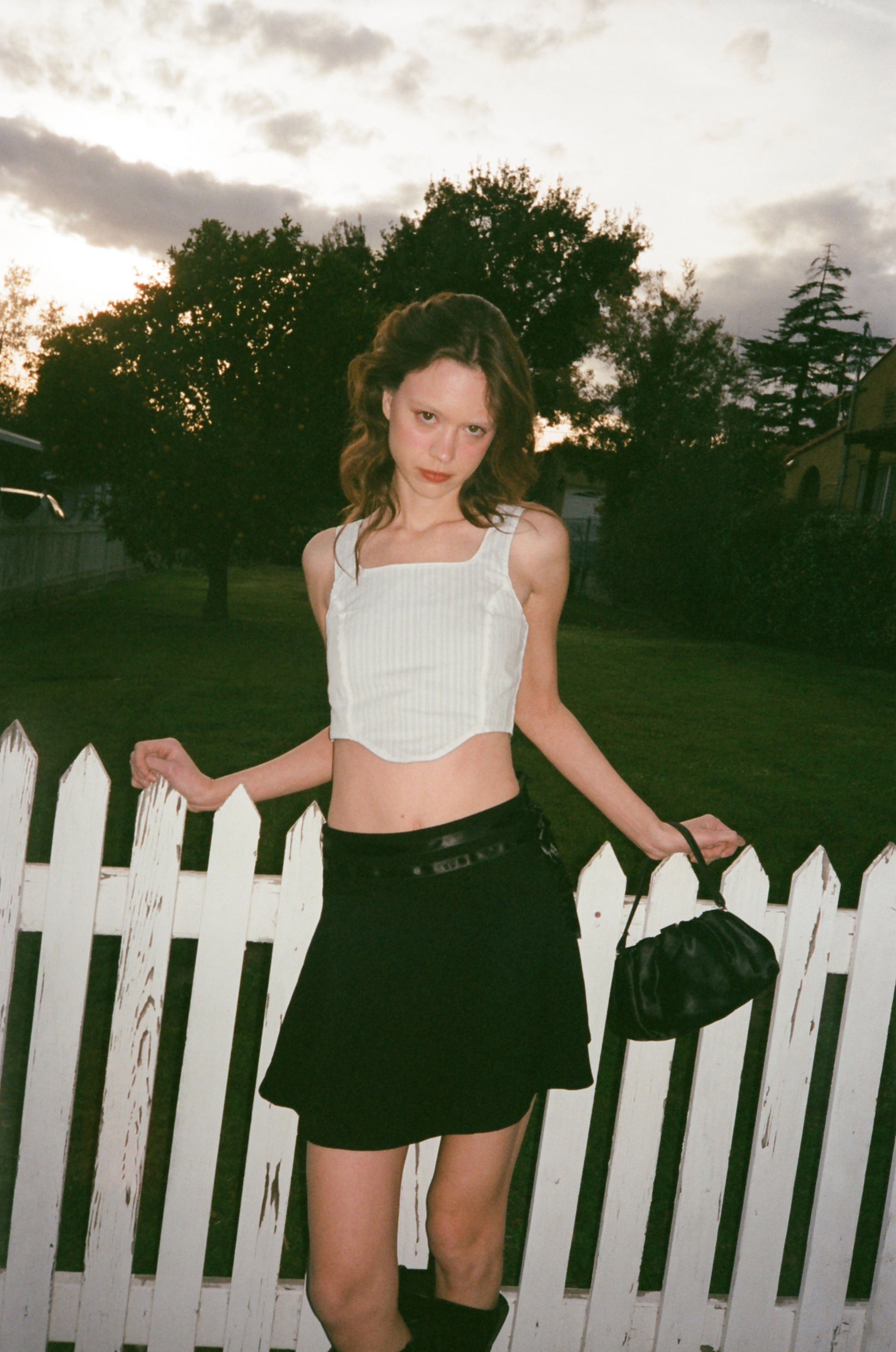 girl wearing white corset and black skirt