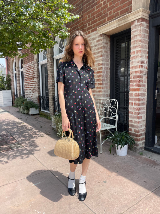 girl wearing black floral print dress