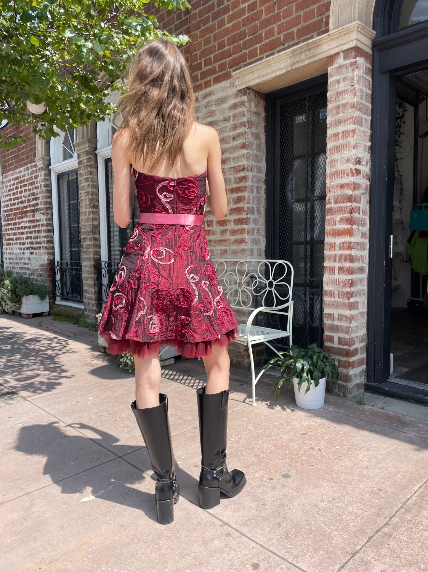 girl in strapless pink dress and black boots