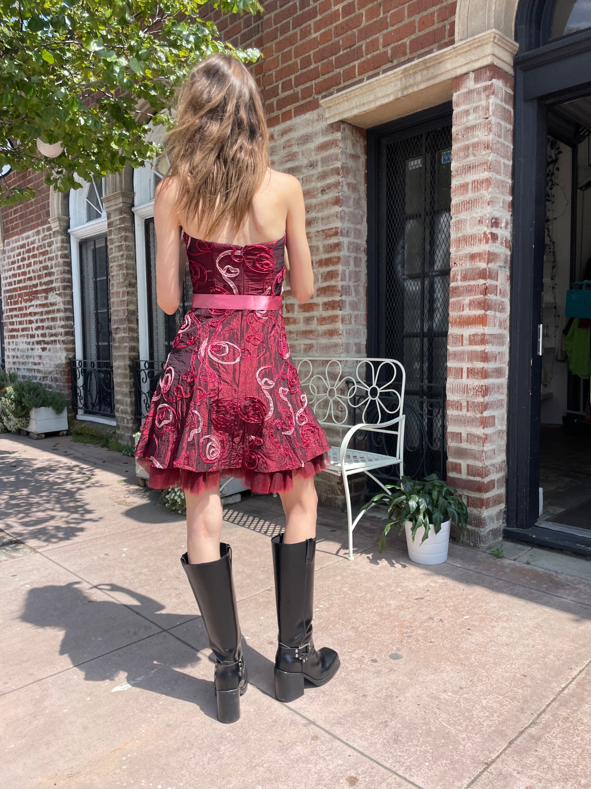 girl in strapless pink dress and black boots