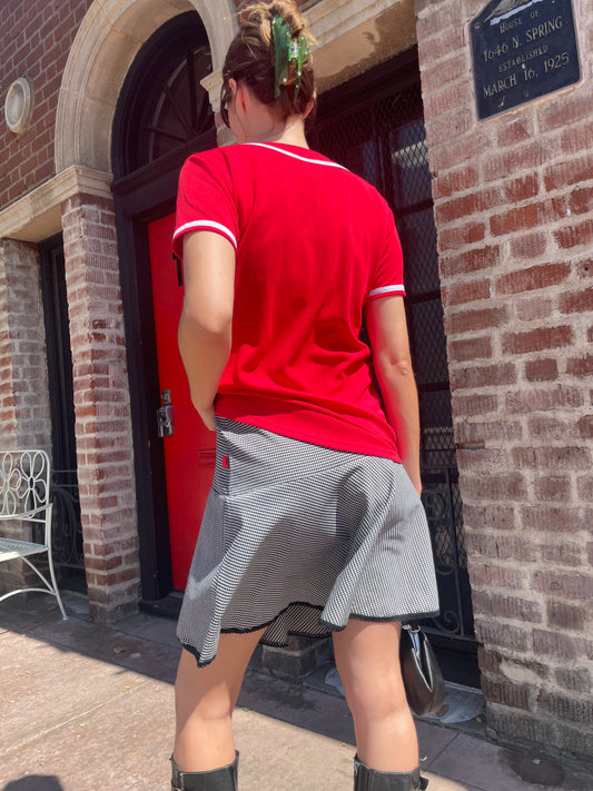 girl in black and white skirt and red top