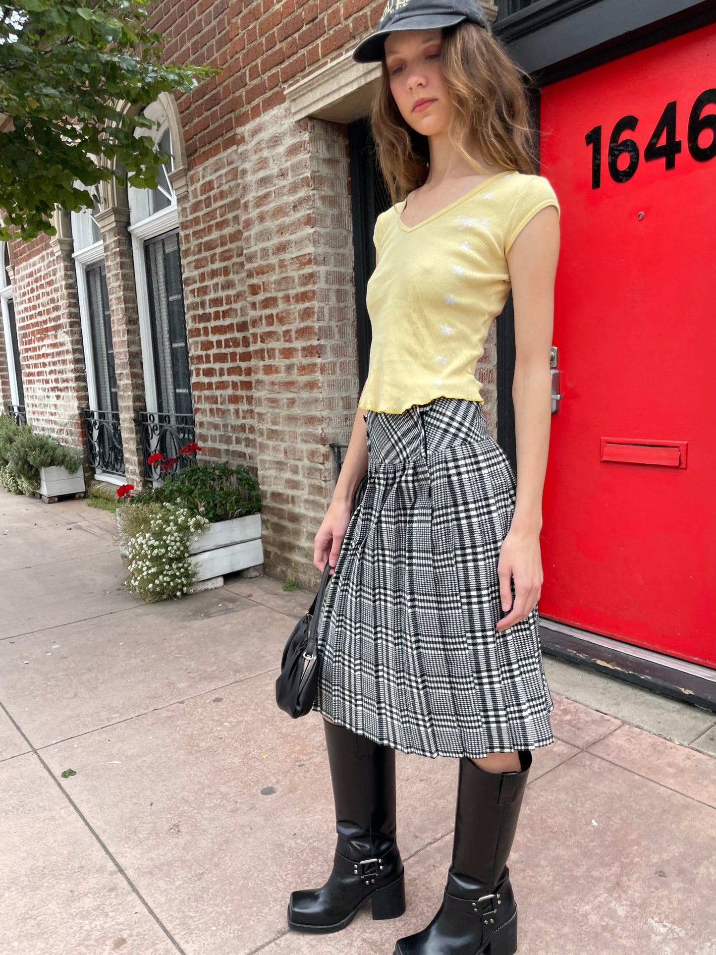 girl in yellow top and black and white skirt