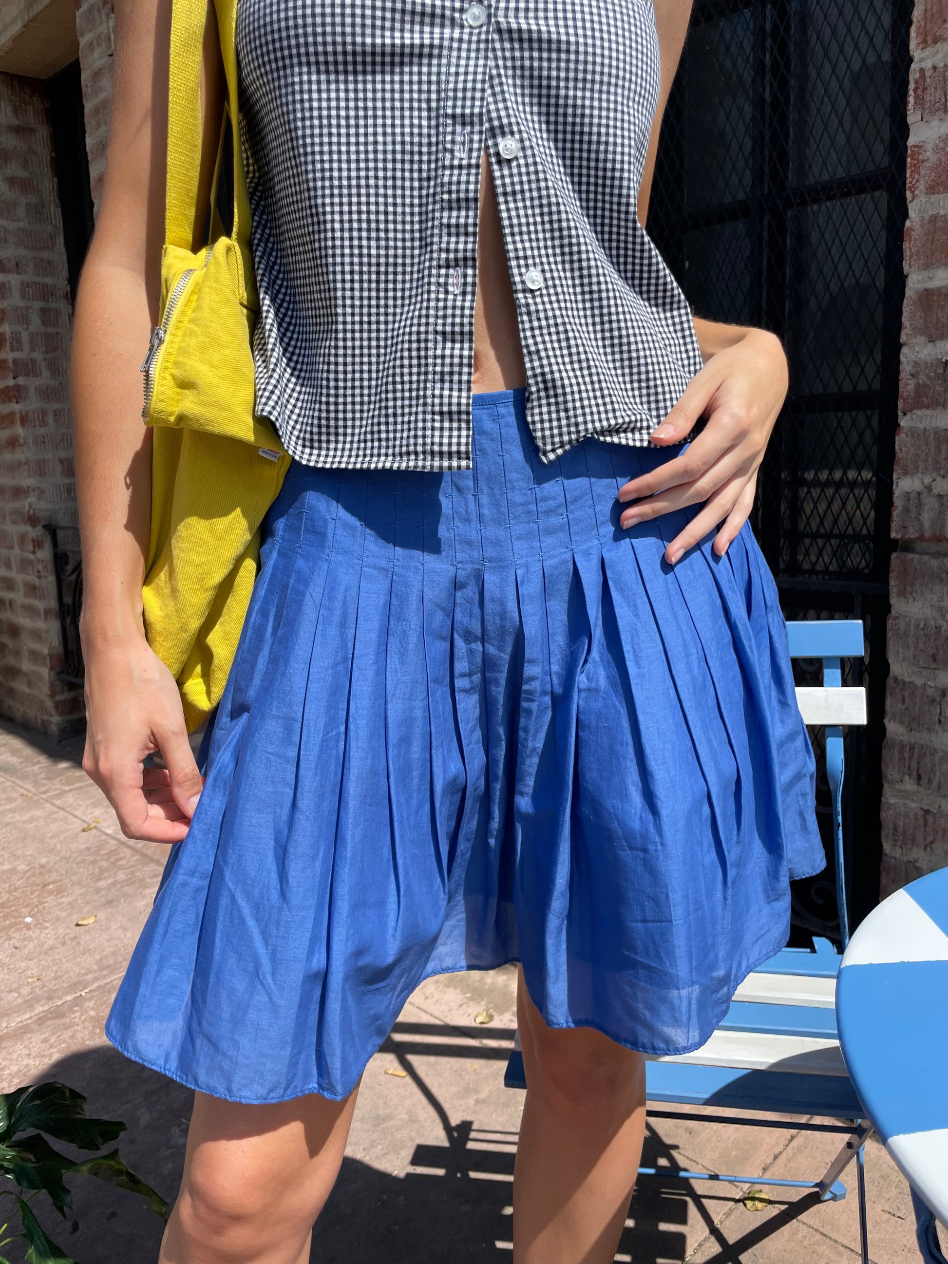 girl in blue skirt and checkered top