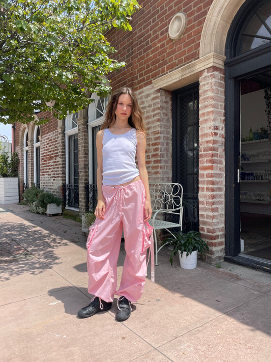 girl wearing baggy pink pants and white tank