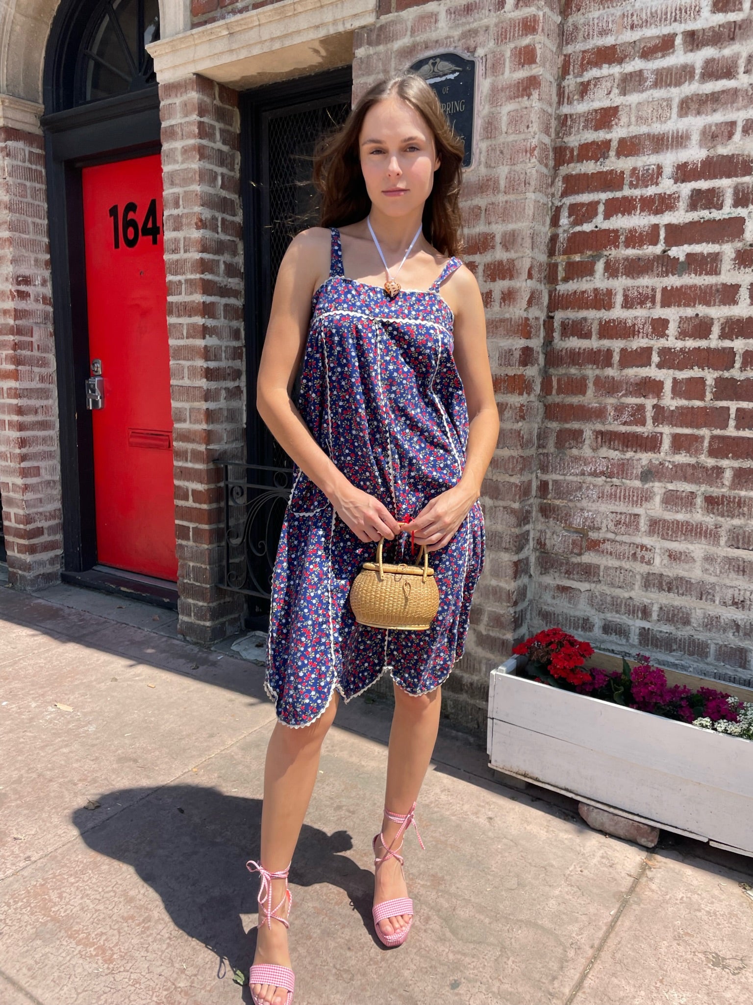 girl in blue floral sleeveless dress