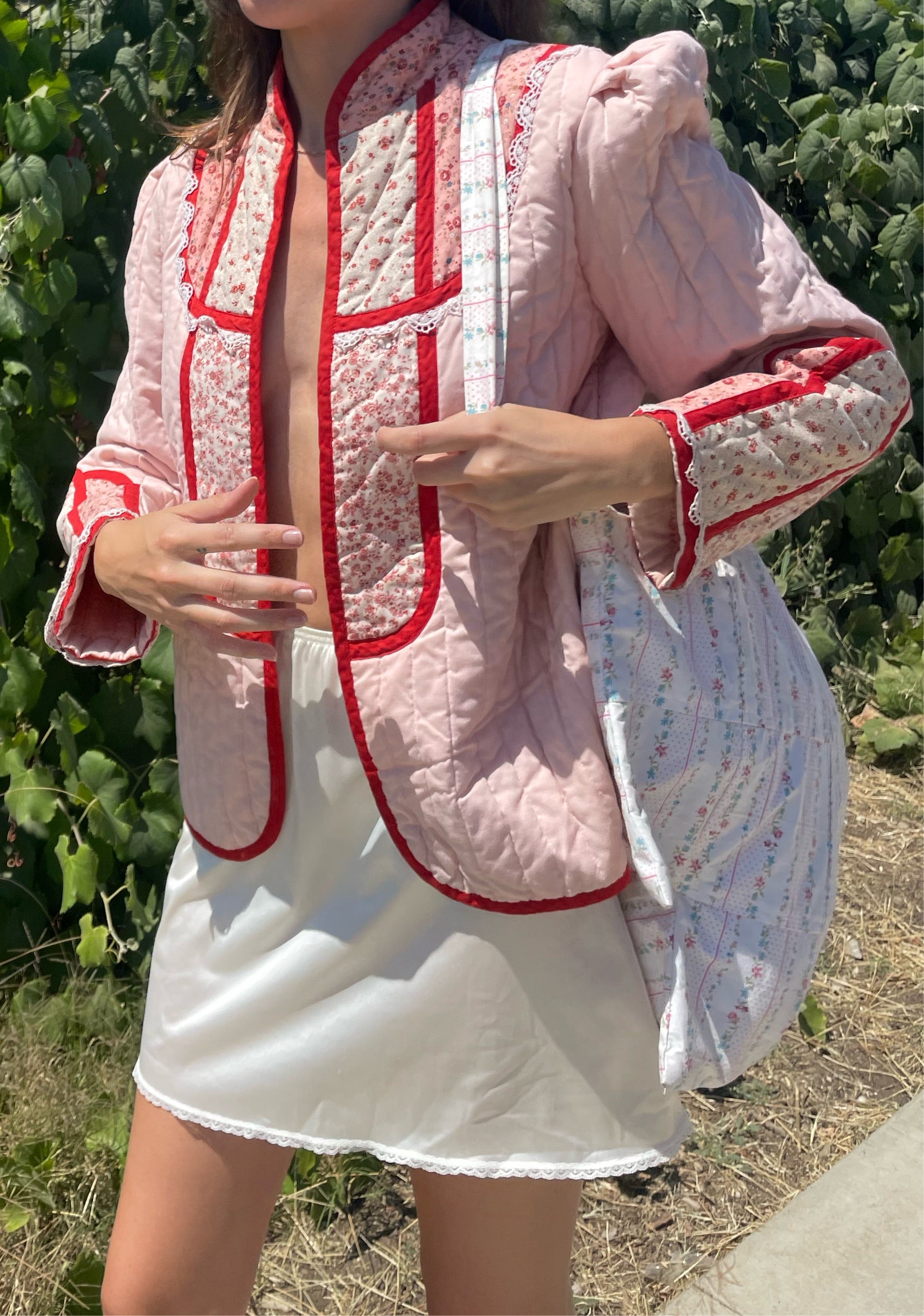 girl in pink jacket and white skirt