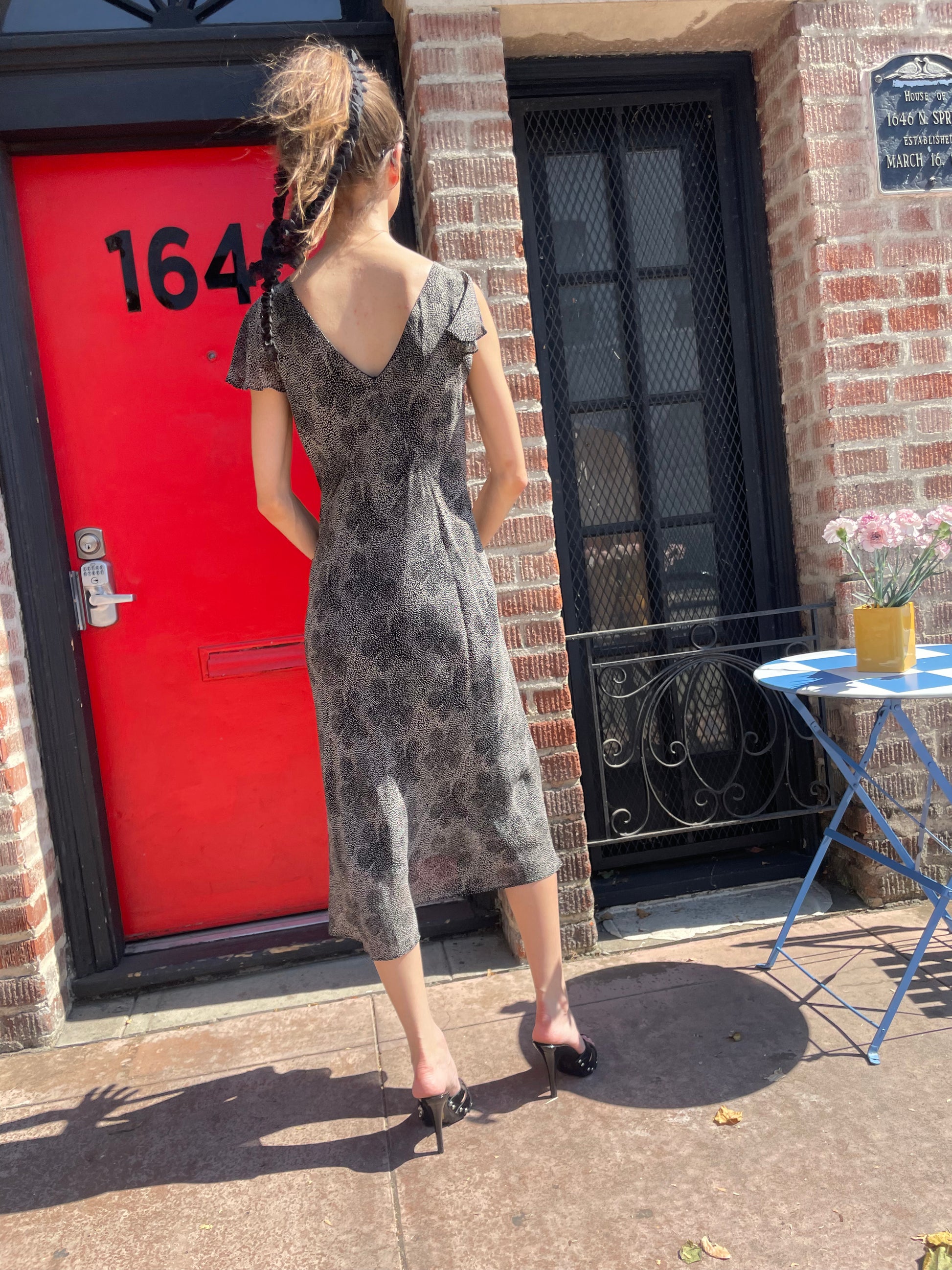 girl in black and white polka dot dress