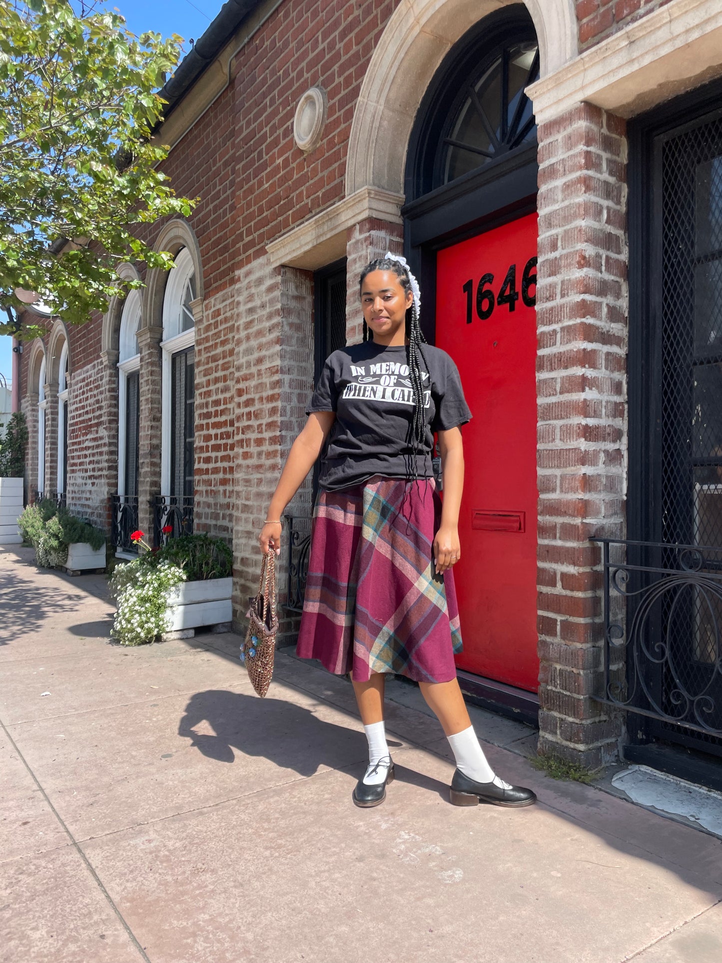 A girl wearing a tee shirt and skirt.