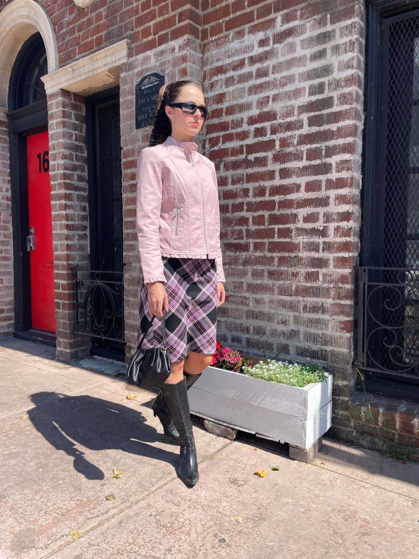 girl in plaid skirt and pink jacket