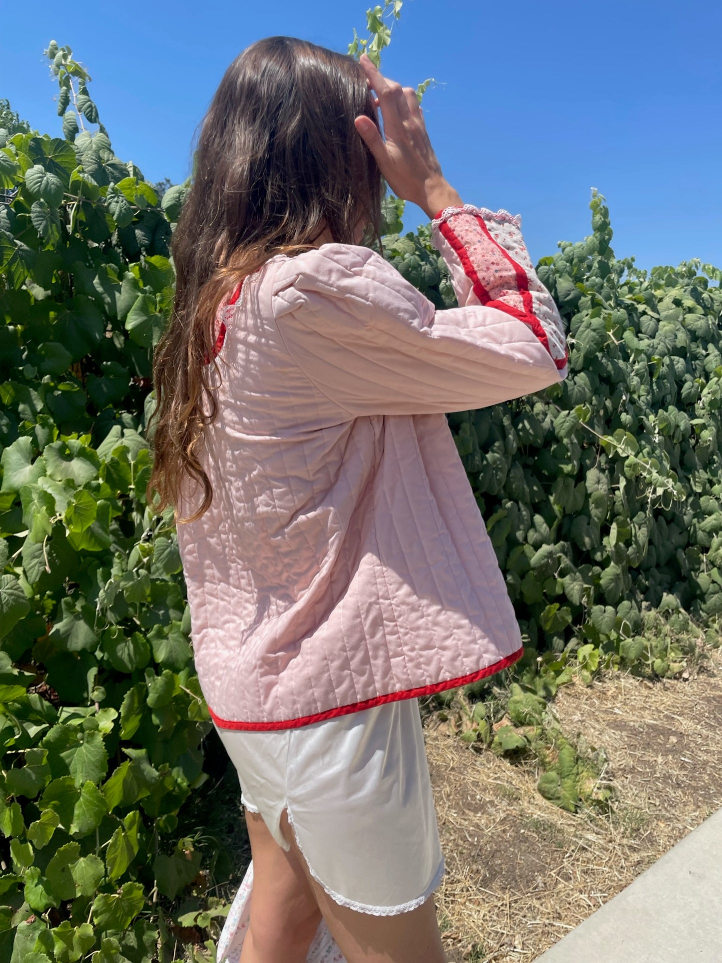 girl in pink jacket and white skirt