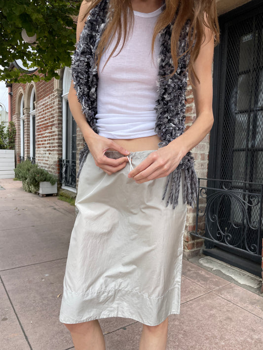 girl in white top and silk skirt