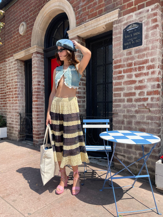 girl in denim top and blue and yellow lace skirt