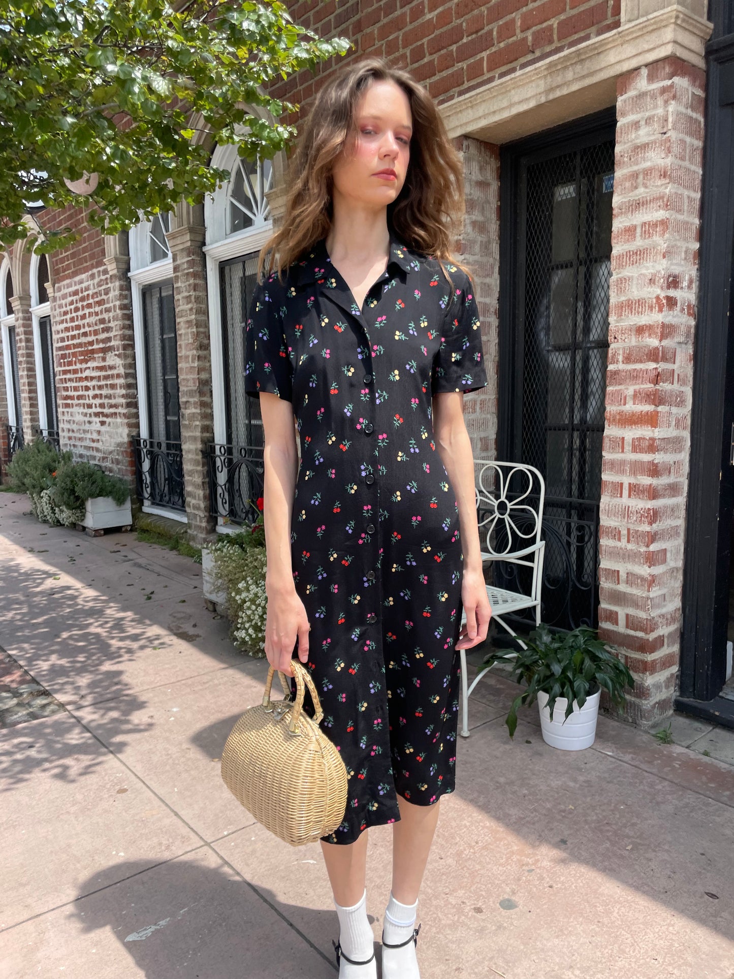 girl wearing black floral print dress