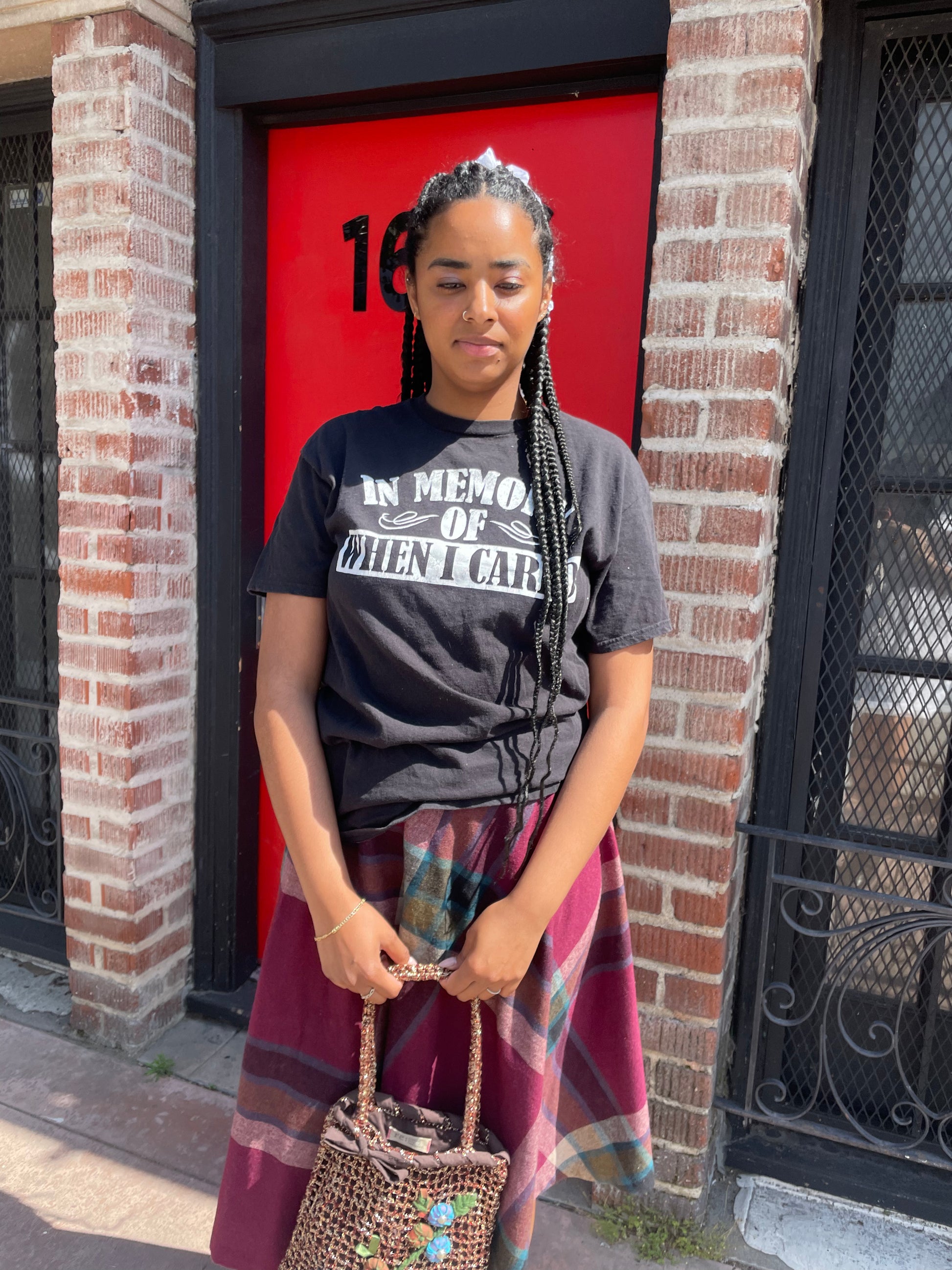 A girl wearing a tee shirt and skirt.