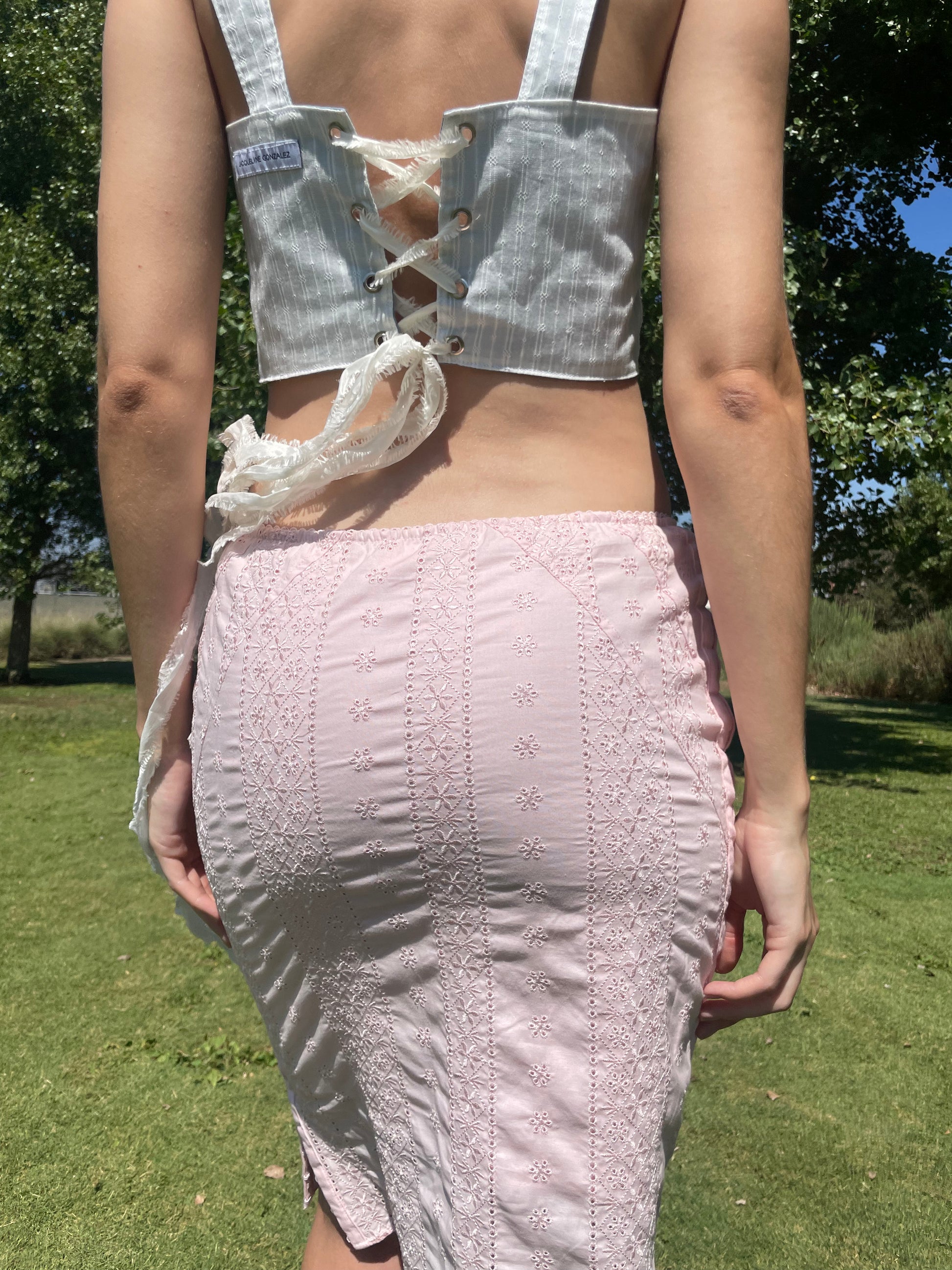 girl in pink skirt and blue corset top