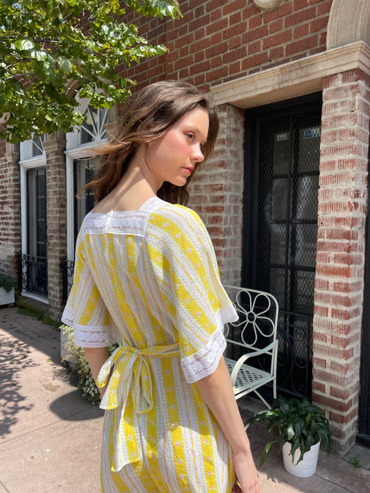 girl wearing long yellow and lace dress