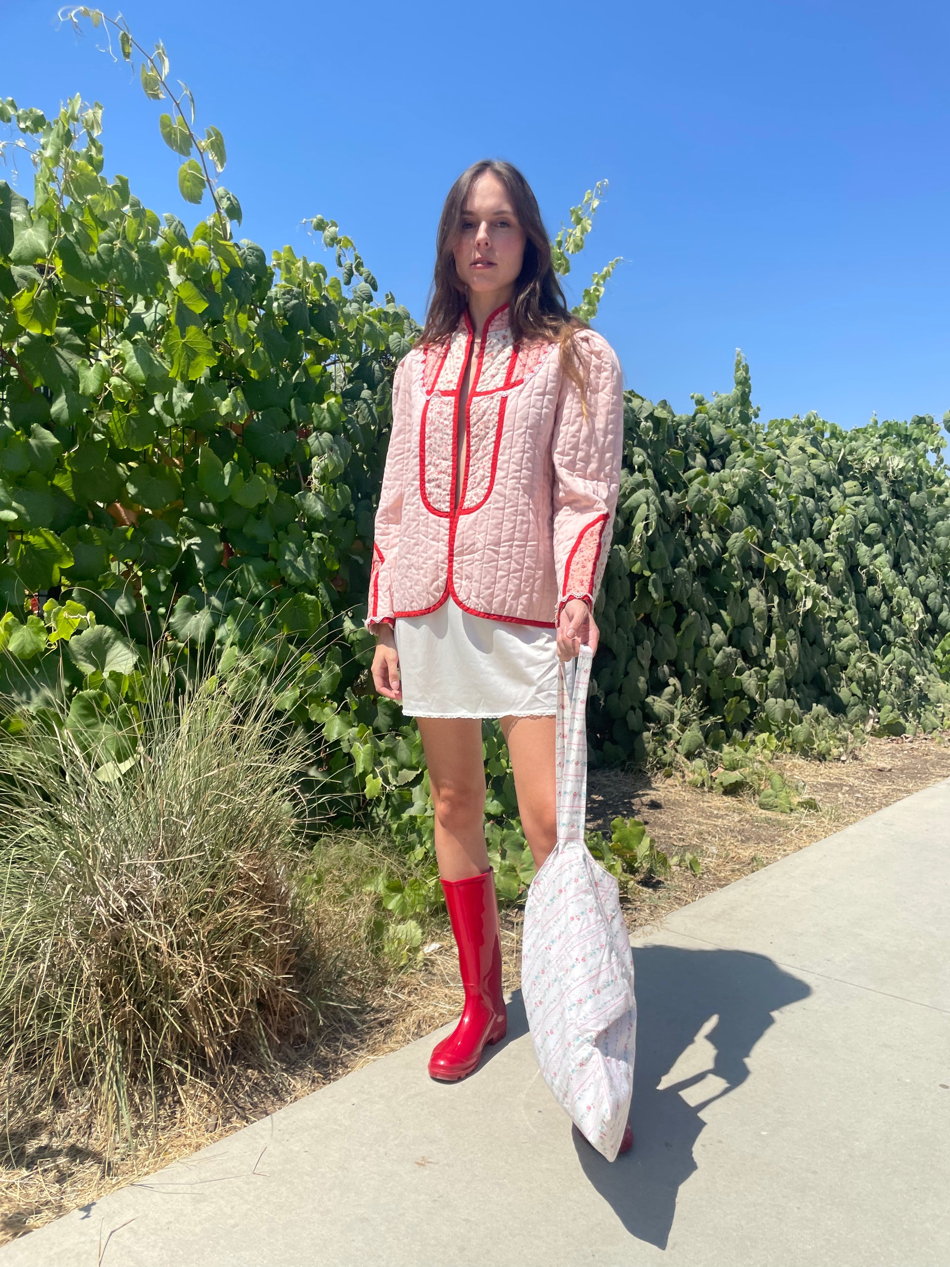 girl in pink jacket and white skirt