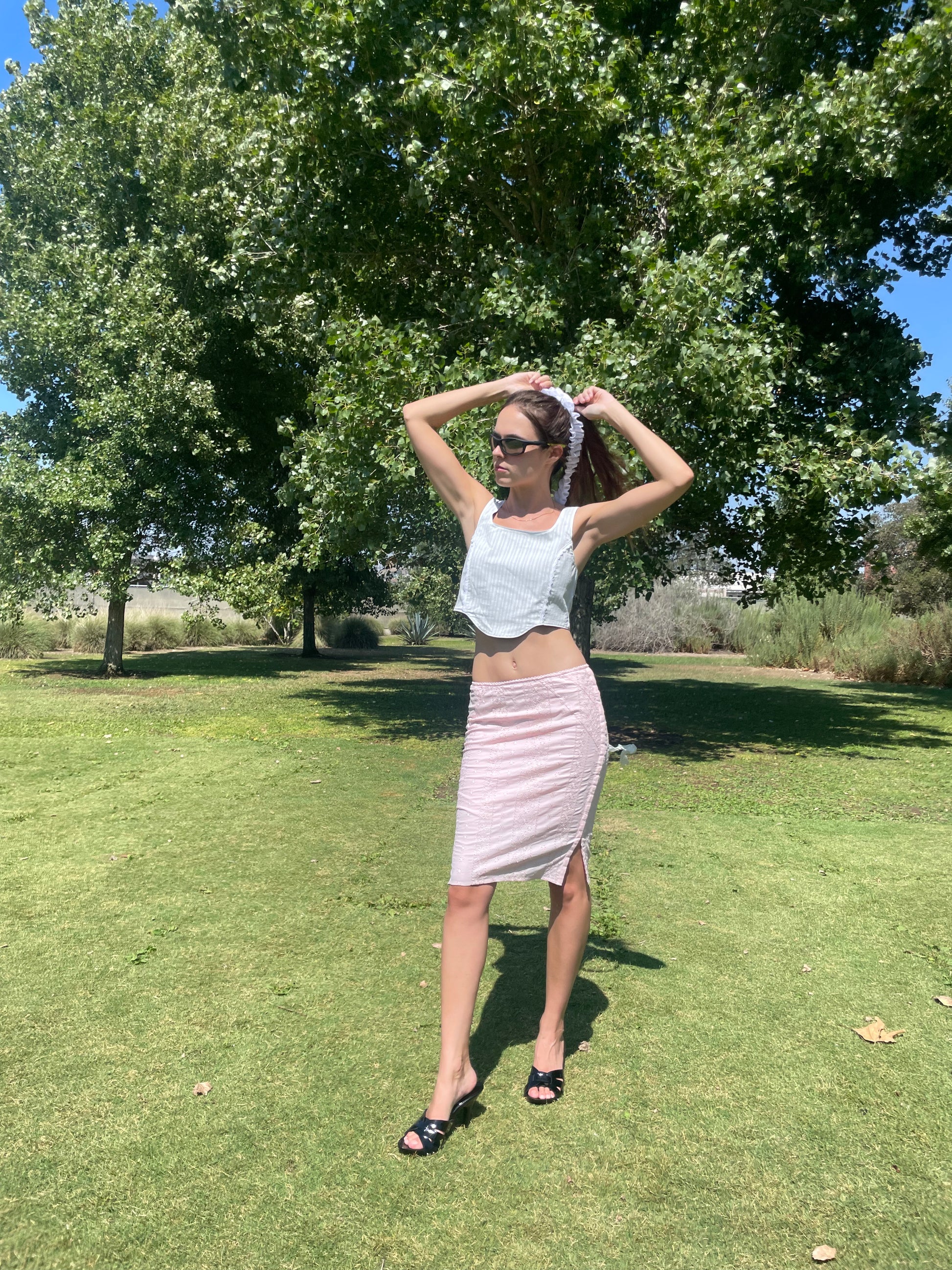 girl in pink skirt and blue corset top