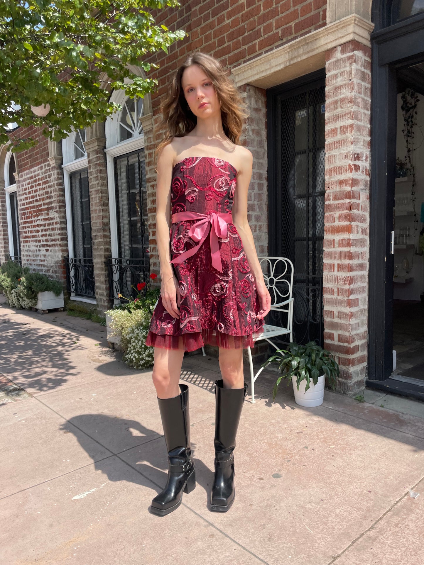 girl in strapless pink dress and black boots