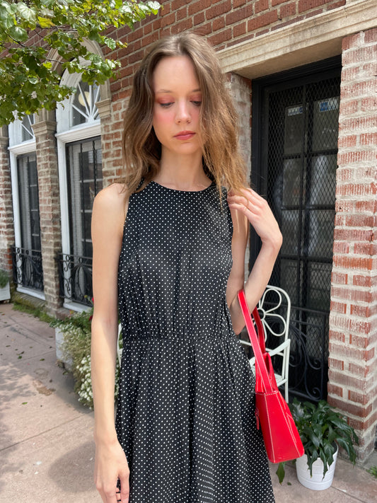 girl wearing black dress and red purse