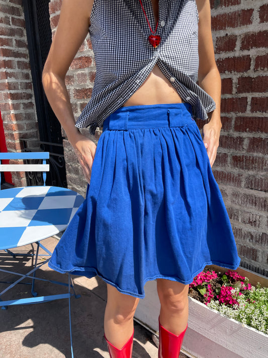 girl in blue skirt and gingham top