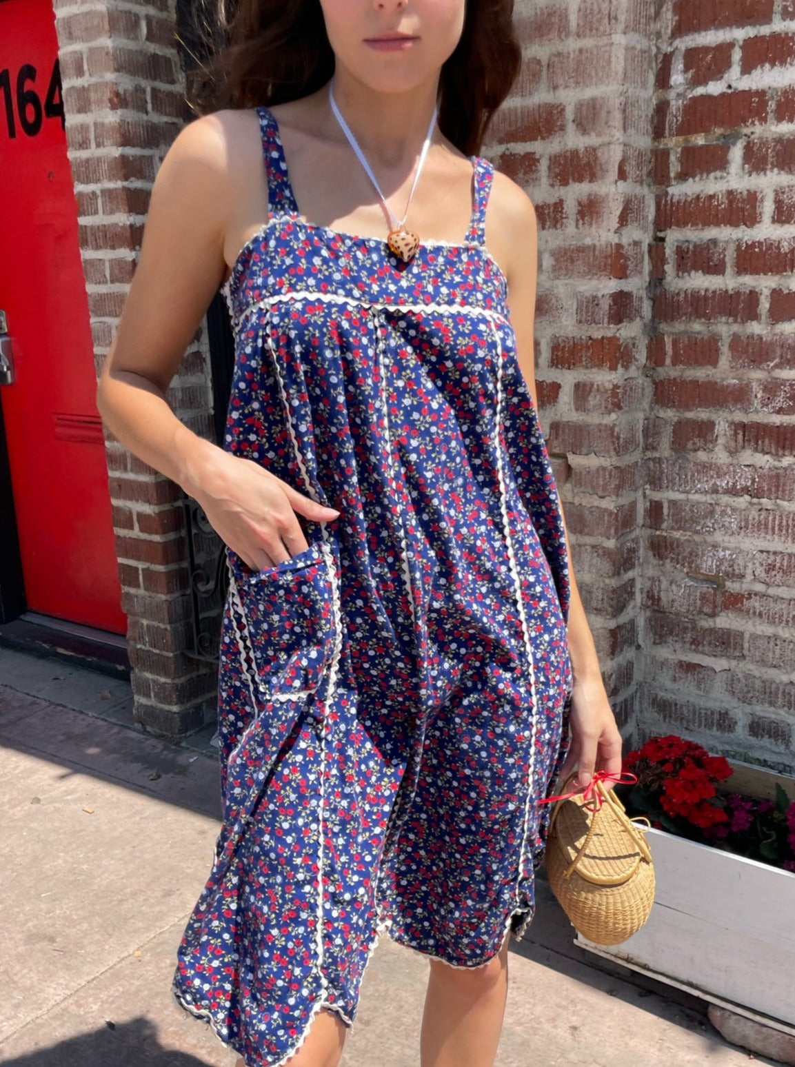 girl in blue floral sleeveless dress