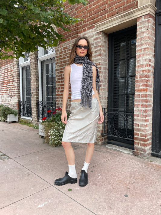 girl in white top and silk skirt