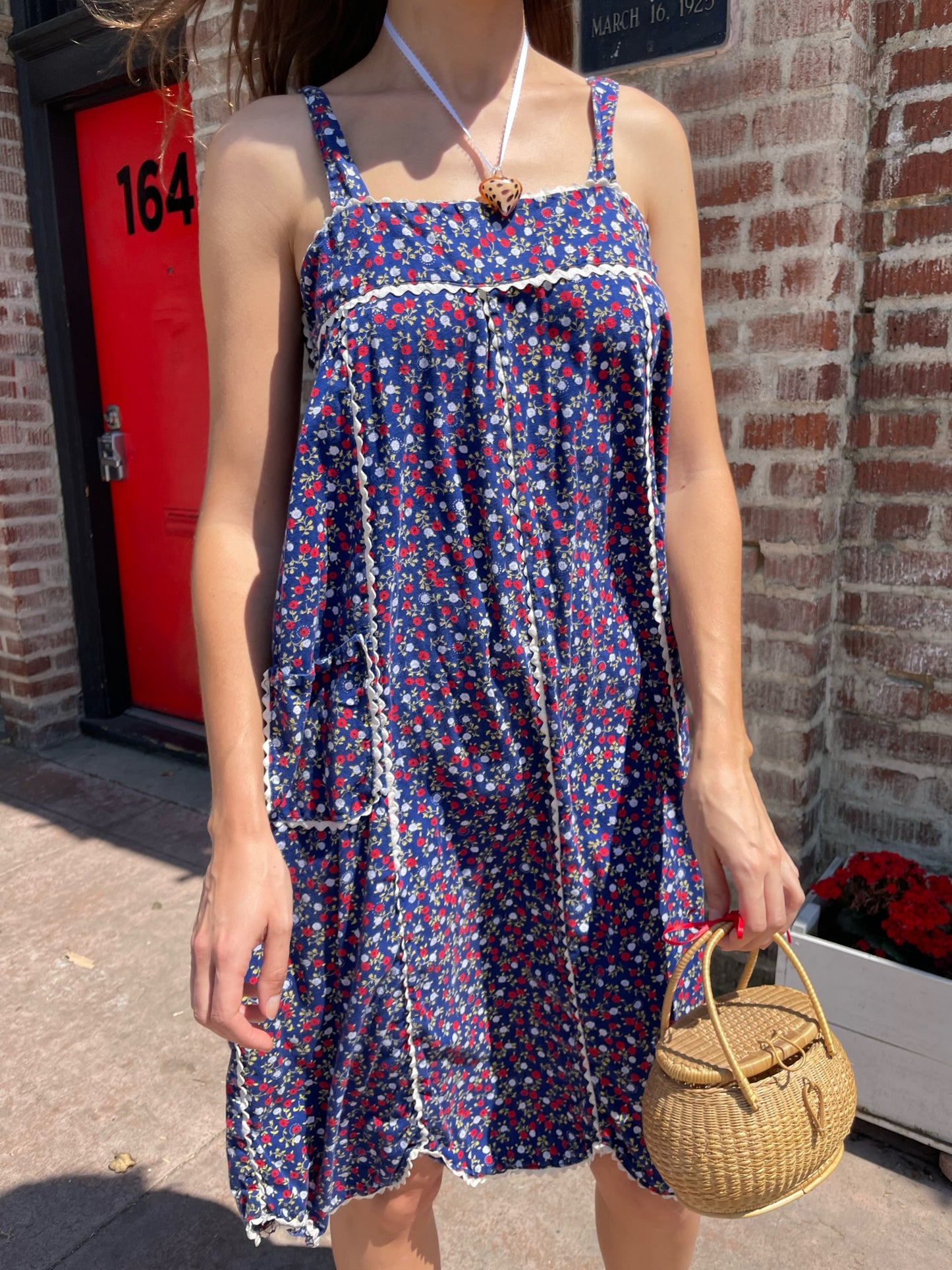 girl in blue floral sleeveless dress