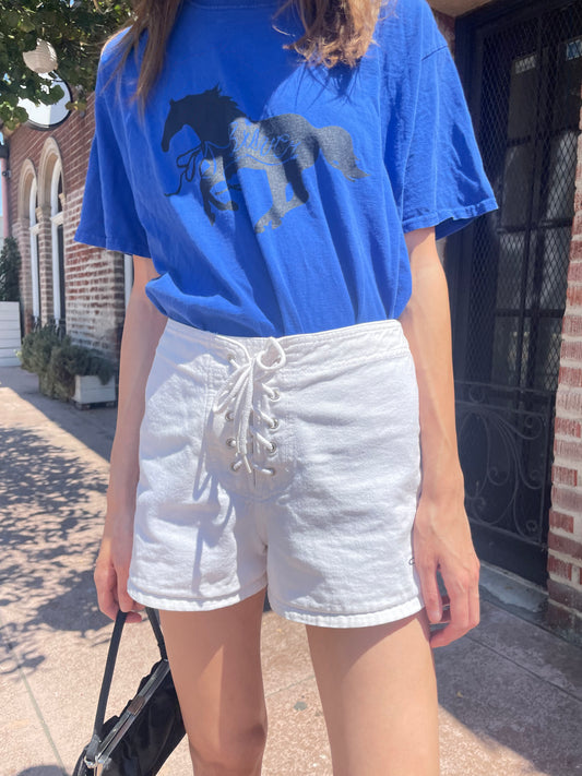 girl in white shorts and blue t-shirt