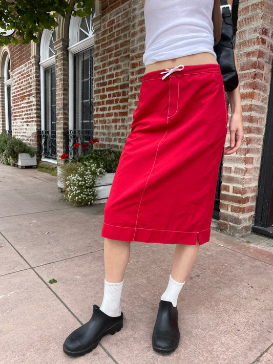 girl in red skirt and white tank top