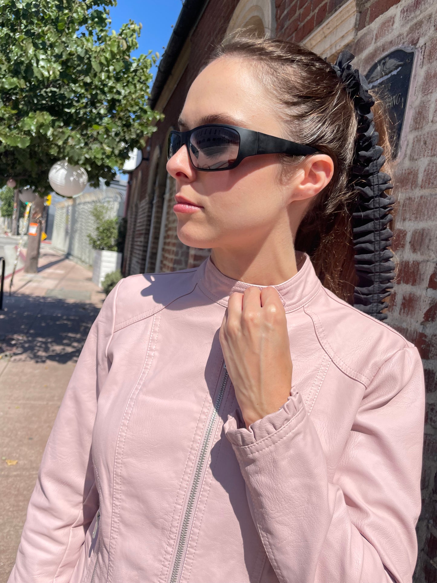 girl in plaid skirt and pink jacket