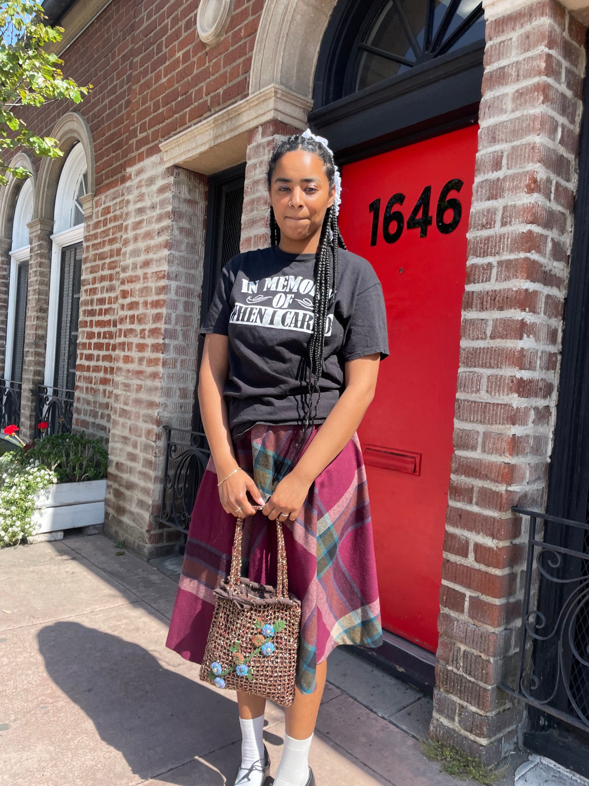 A girl wearing a tee shirt and skirt.