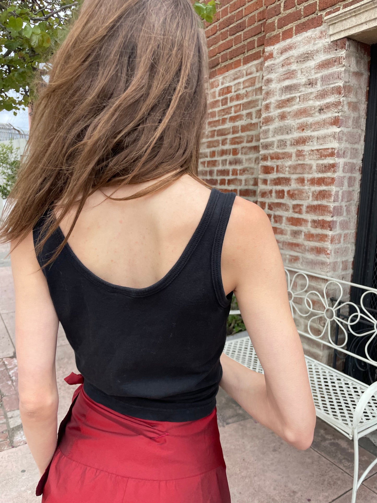 back of girl wearing black tank top with fish on it