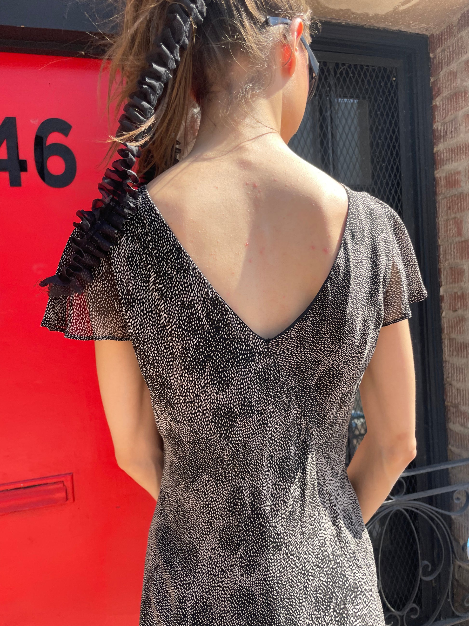 girl in black and white polka dot dress