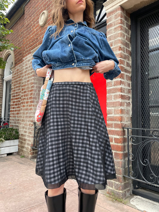 girl wearing denim jacket and gingham skirt