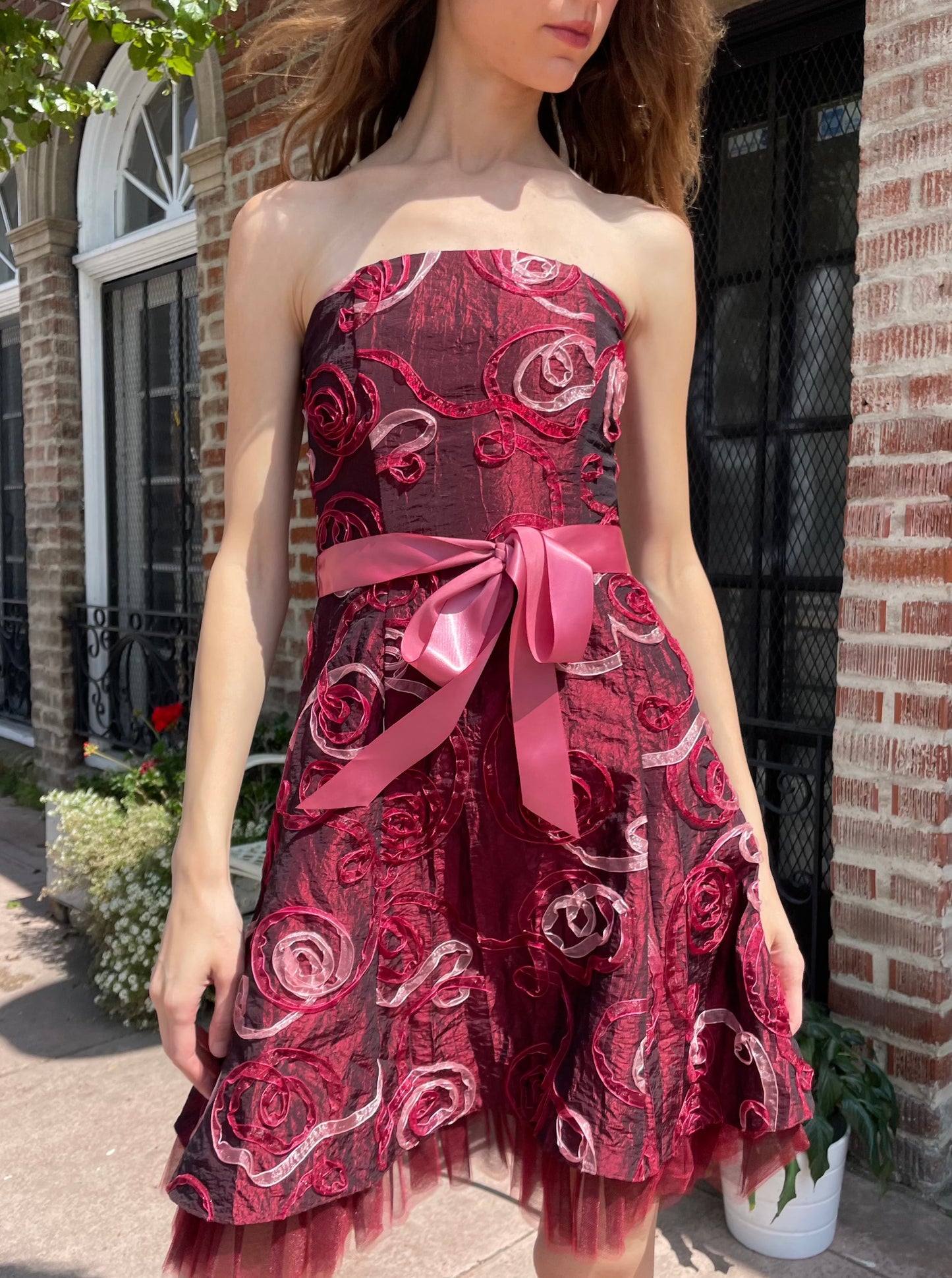 girl in strapless pink dress and black boots