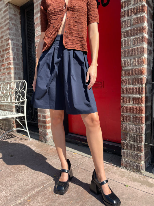 girl in navy skirt and orange top