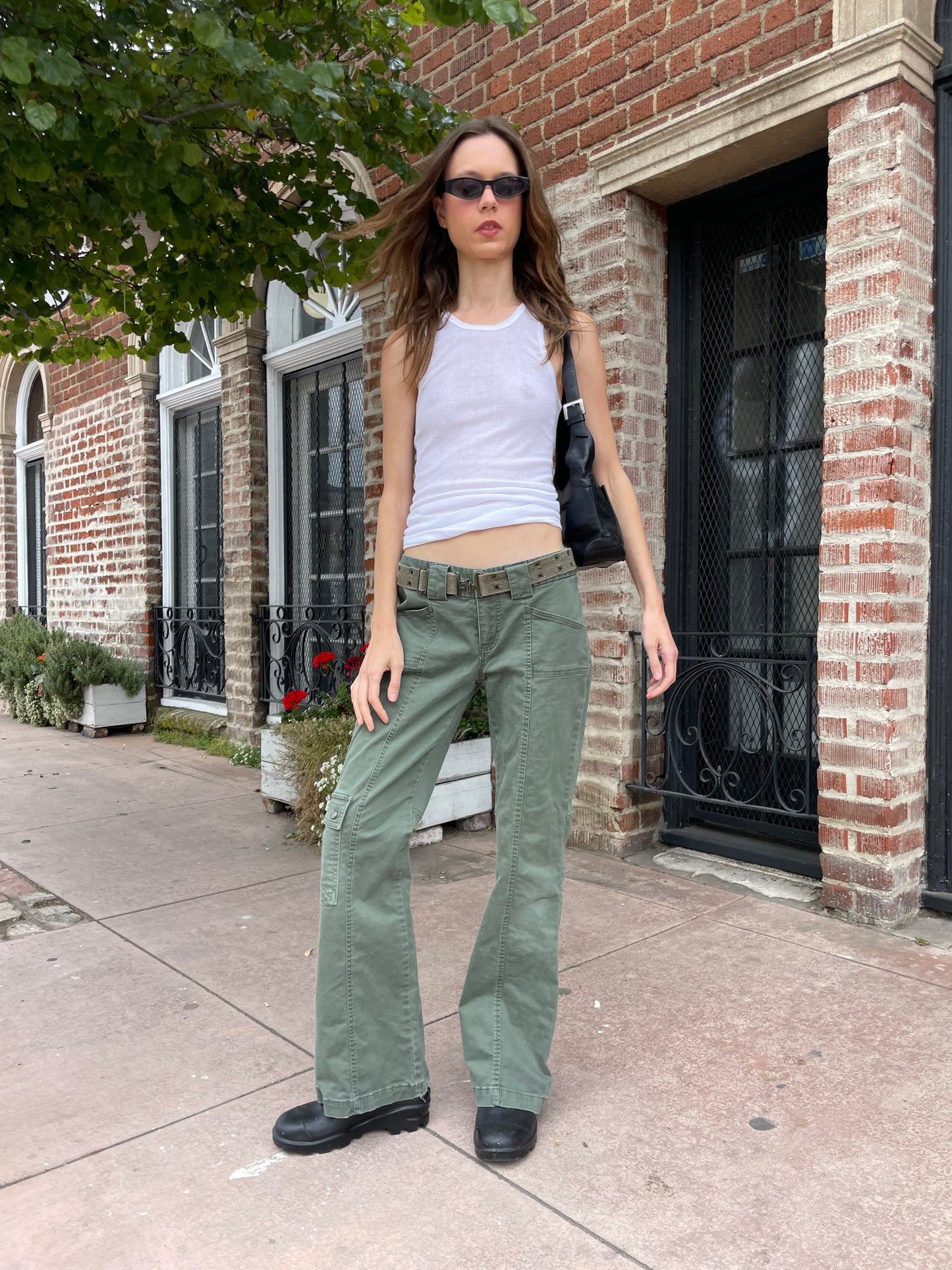 girl wearing white tank and green cargo pants