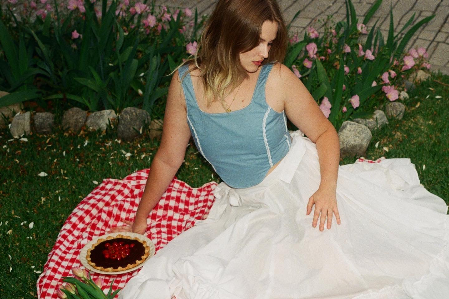 girl wearing blue corset and white skirt