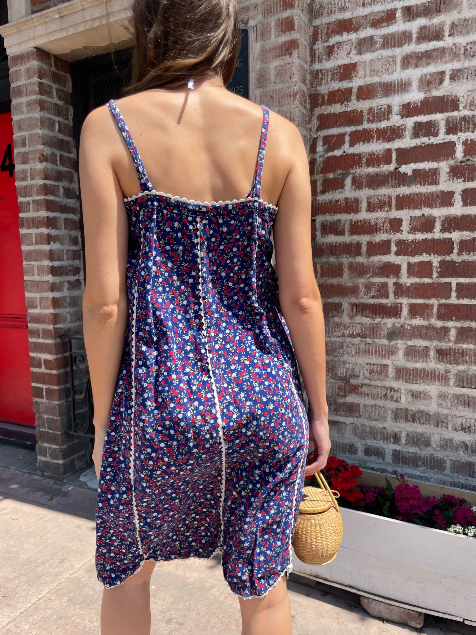 girl in blue floral sleeveless dress