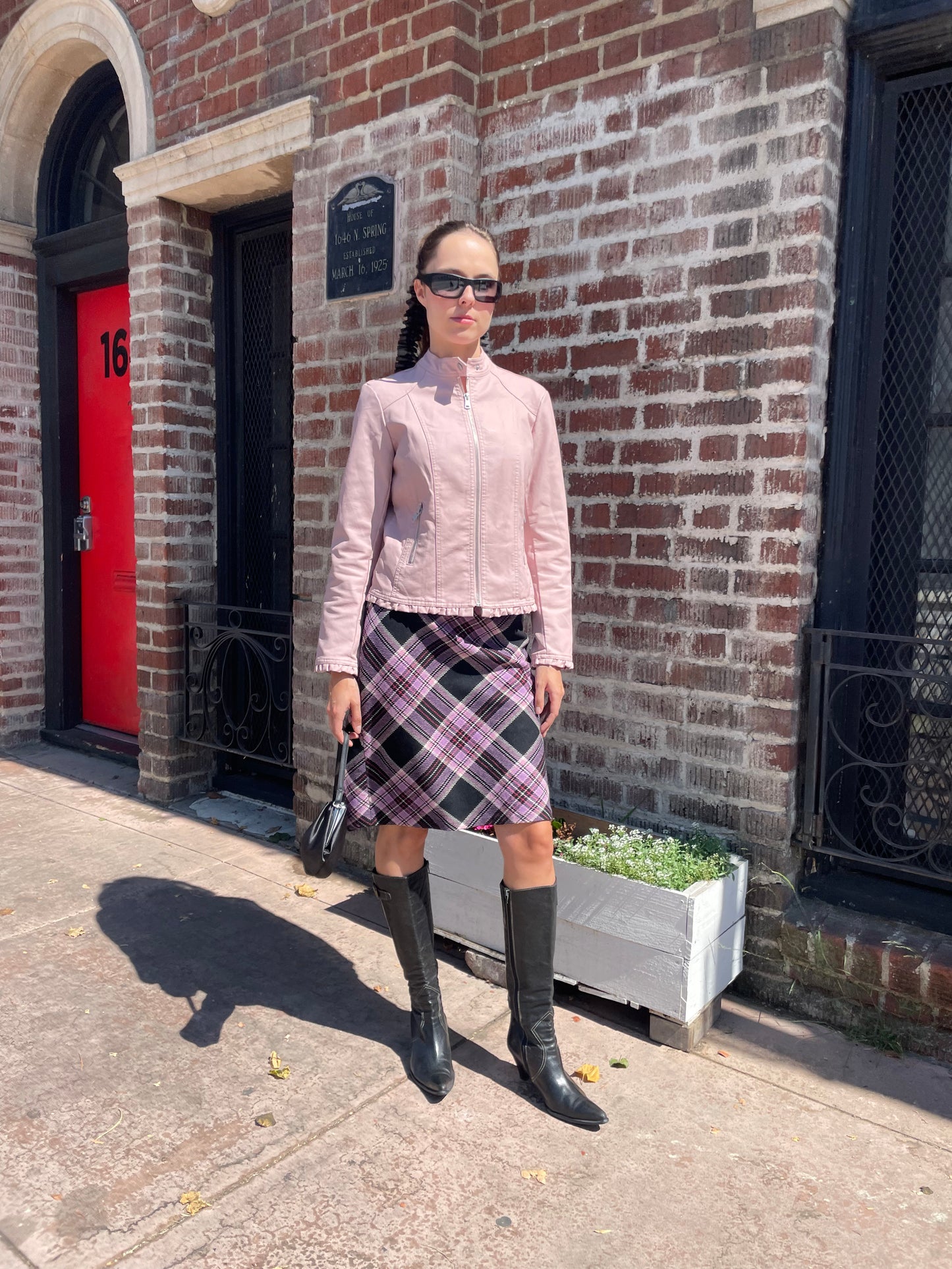 girl in plaid skirt and pink jacket