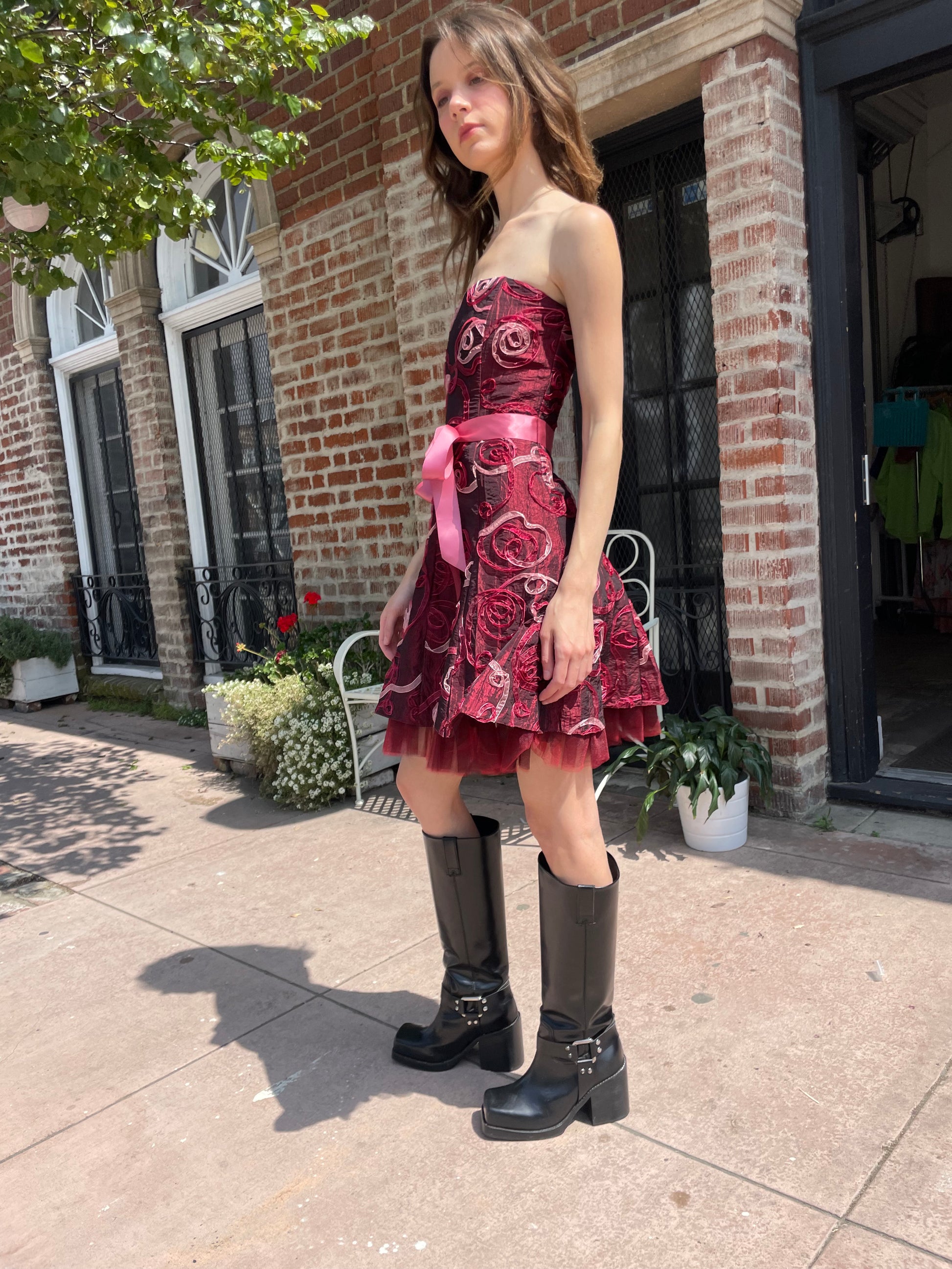 girl in strapless pink dress and black boots