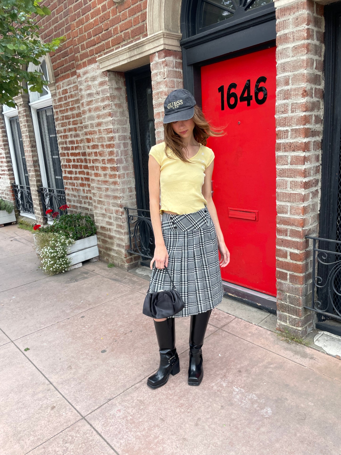 girl in yellow top and black and white skirt