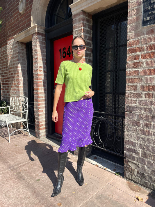 girl in green top and purple skirt