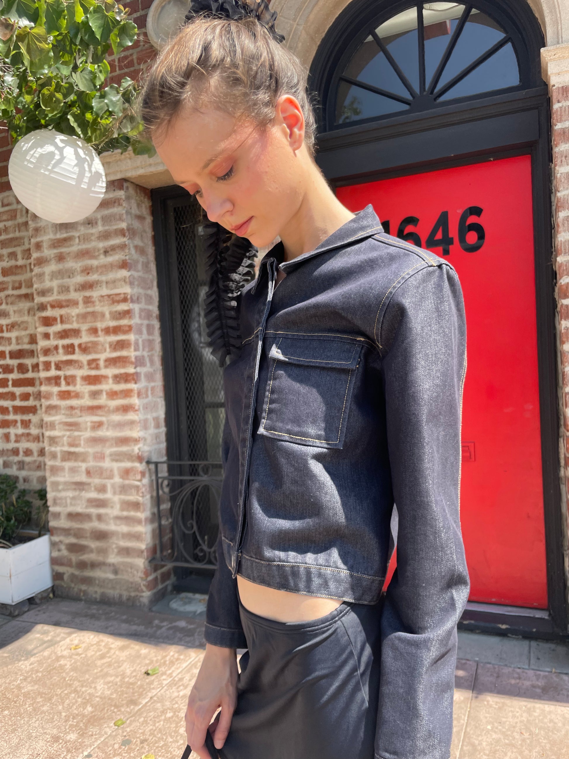 girl in denim jacket, black skirt and leather boots