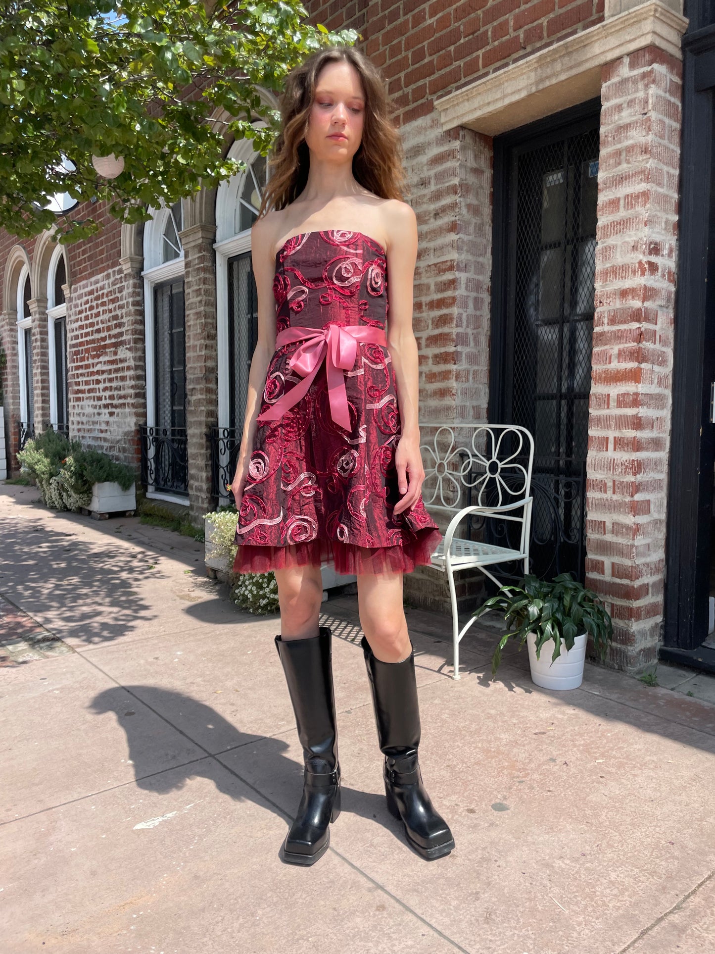 girl in strapless pink dress and black boots