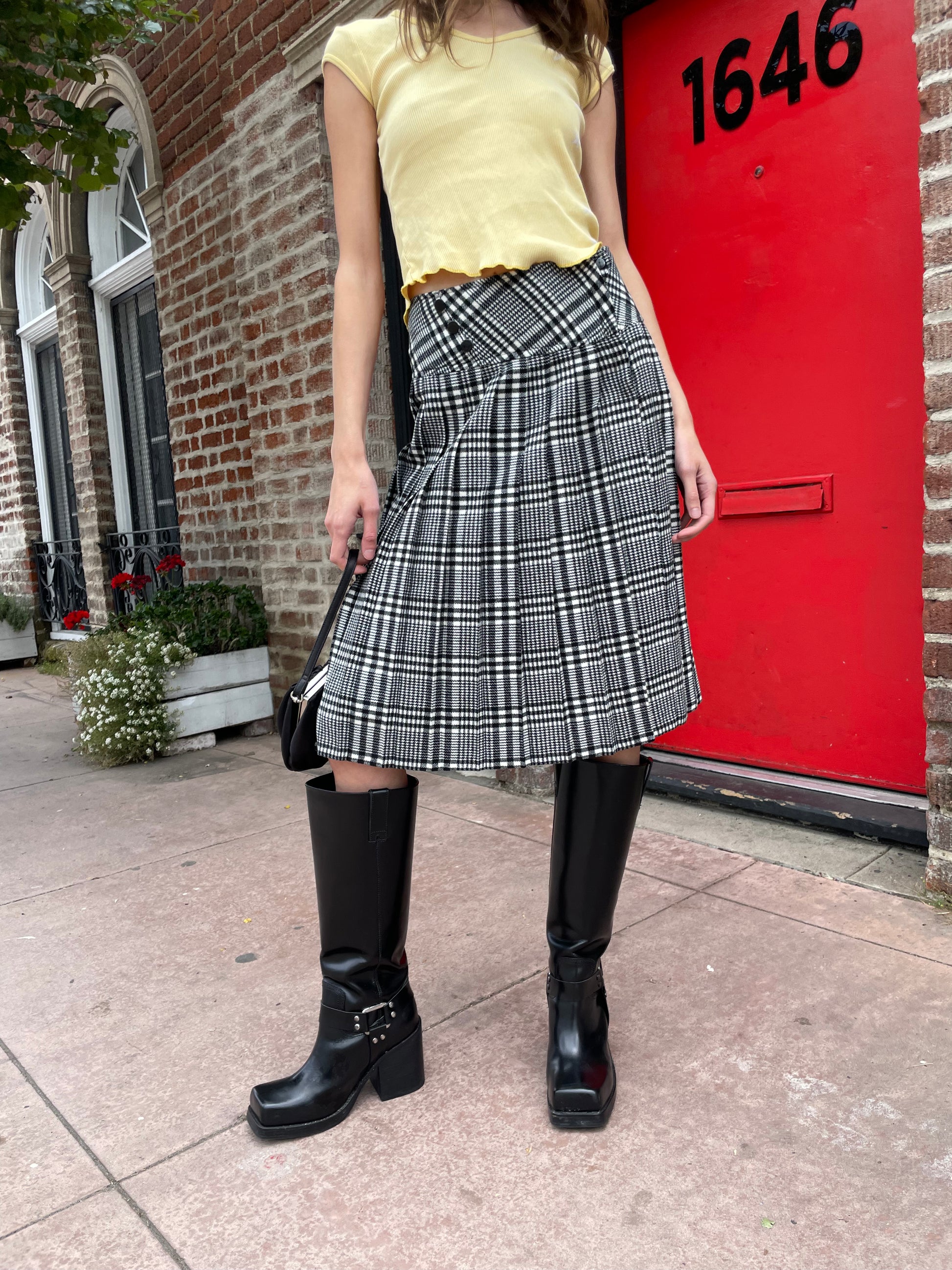 girl in yellow top and black and white skirt