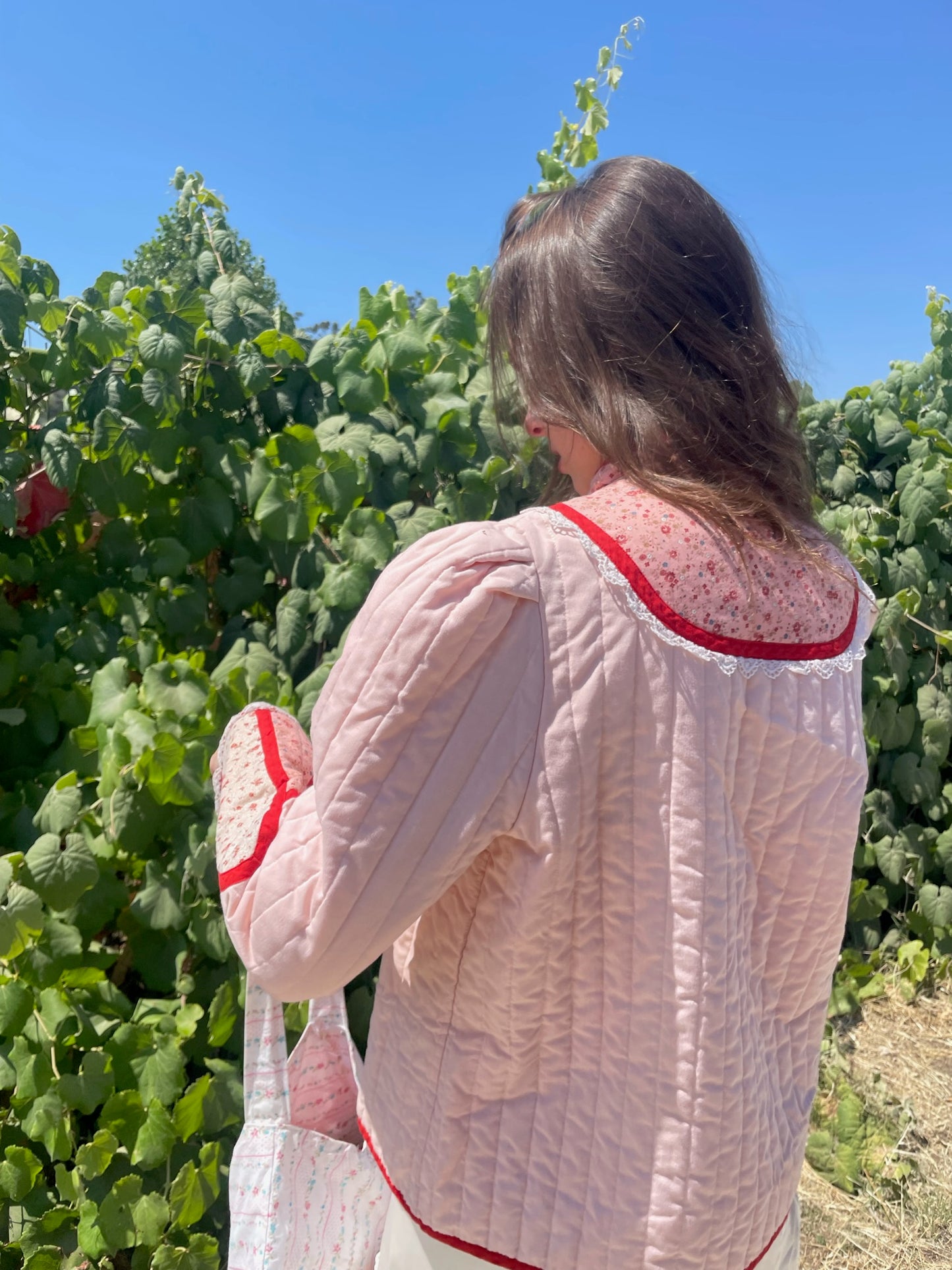 girl in pink jacket and white skirt