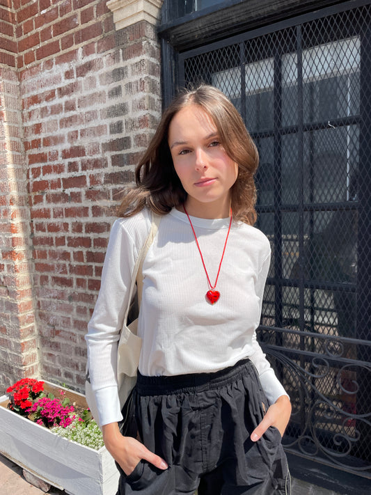 girl in white long sleeve top and black shorts