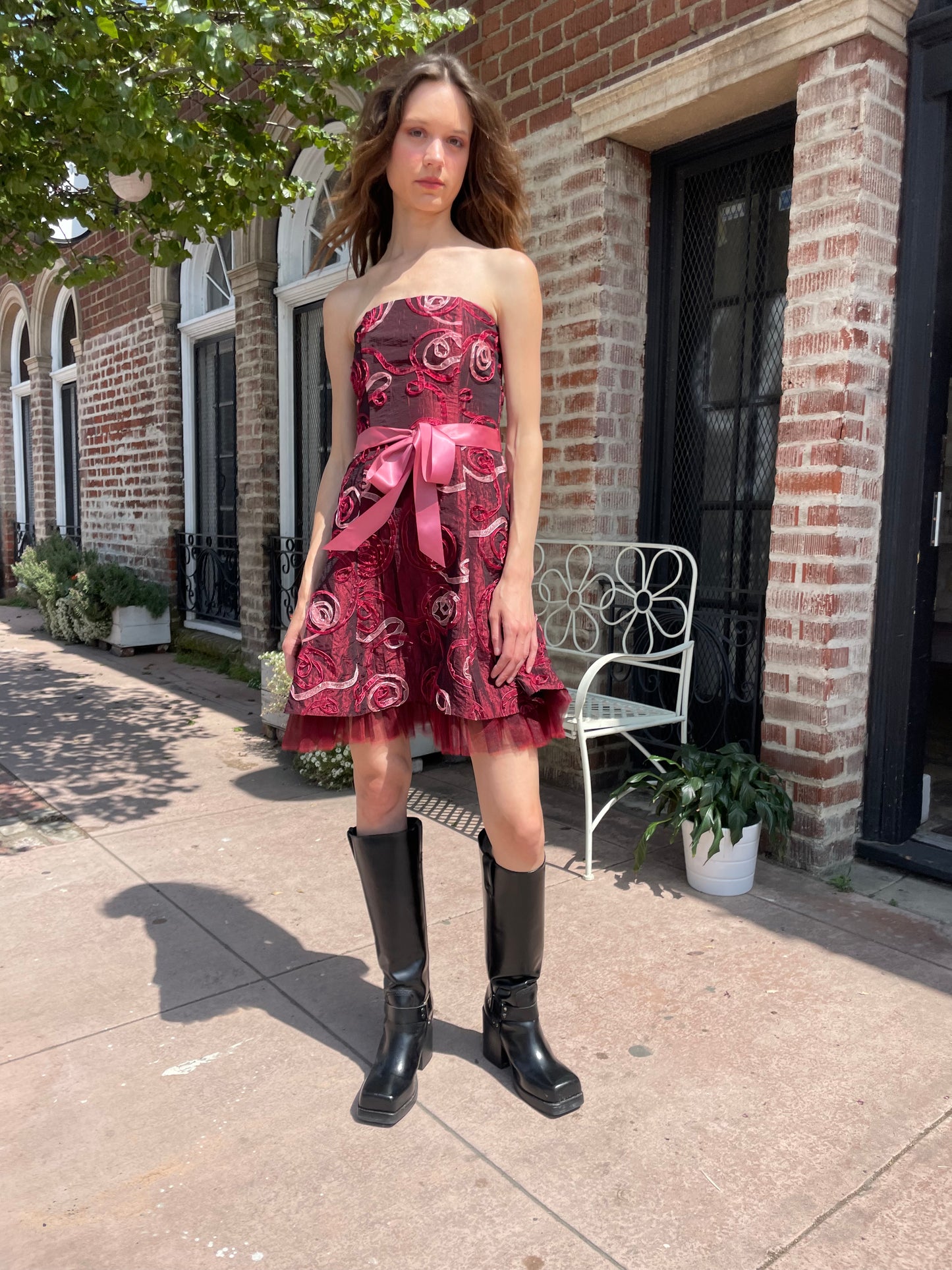 girl in strapless pink dress and black boots